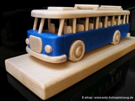 Spielzeugbus - blau Holgeschenk auf hölzerner Stand